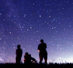 People gazing up at night sky.