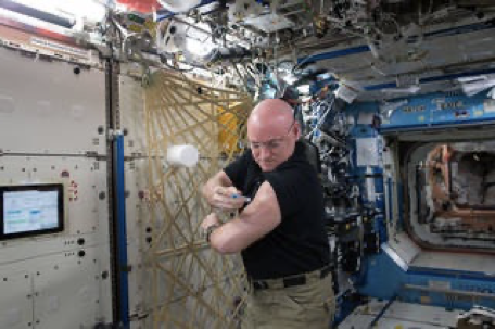 Astronaut Scott Kelly self-administering a flu vaccine aboard the International Space Station