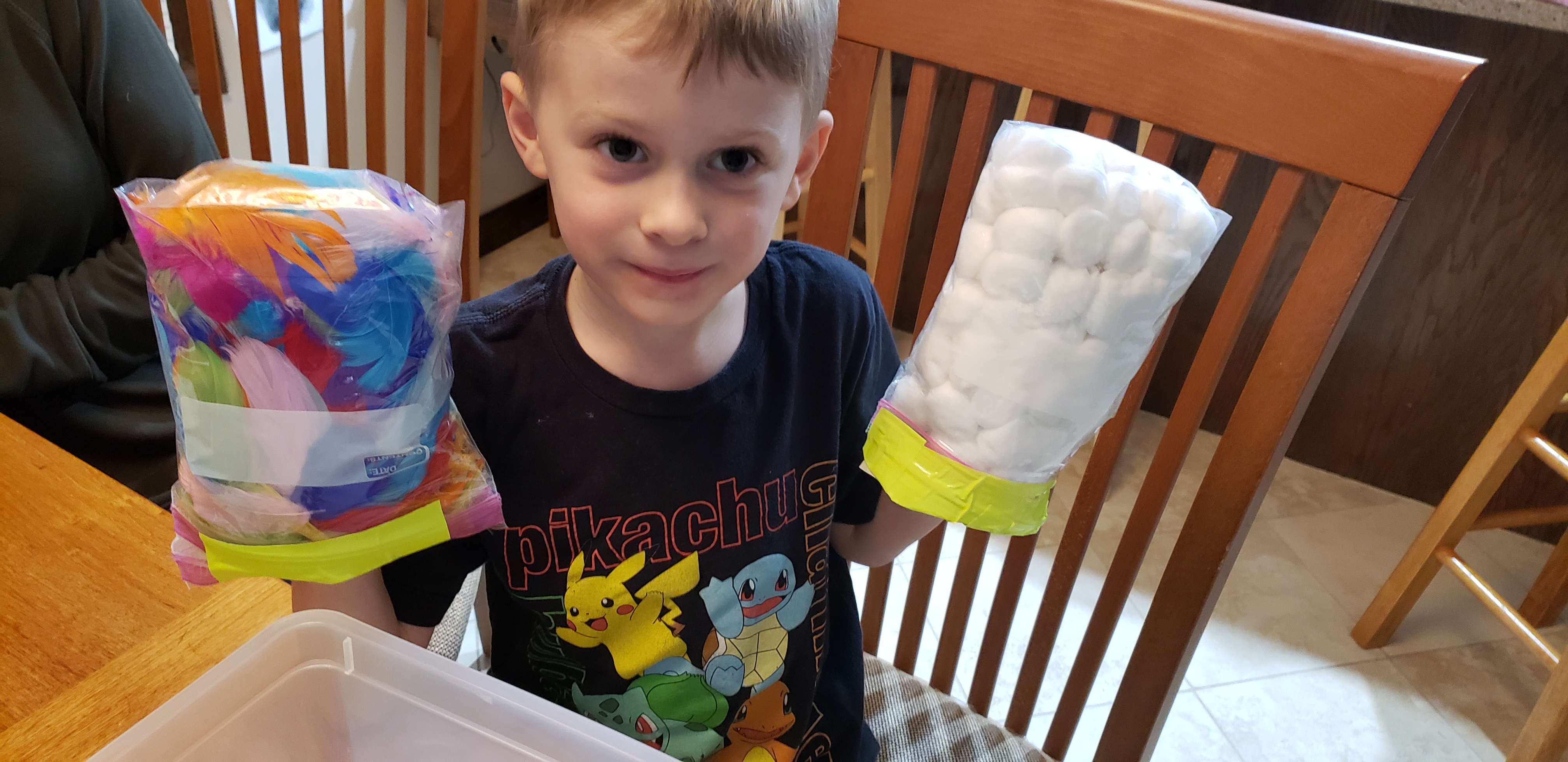 Student Gregory holding experimental gloves.