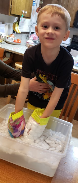 Smiling student performing experiment.