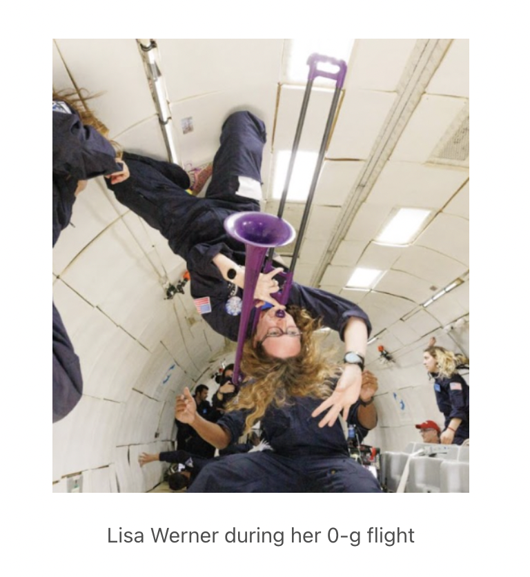 Lisa plays the trombone upside down during a 0-g flight