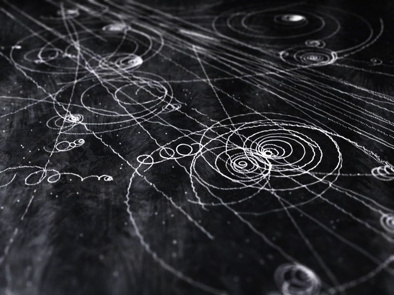 Tracks made by different particles originating from cosmic rays.