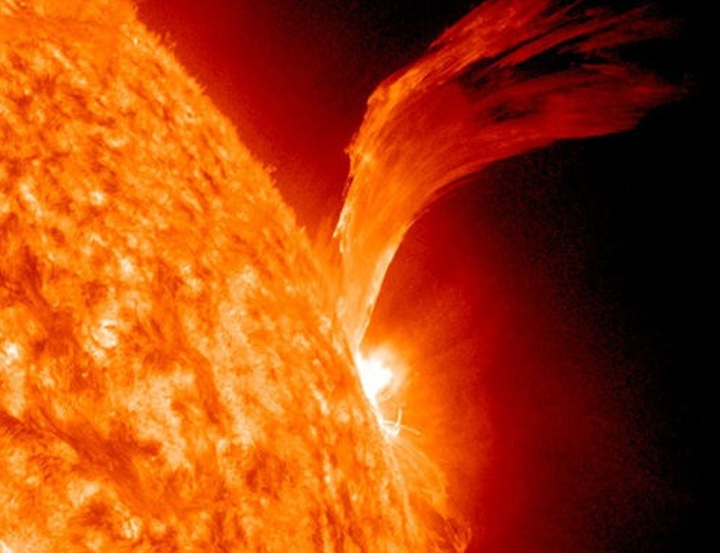 This bright orange image of the sun shows a huge flare, many times the Earth in size being ejected from the right side.